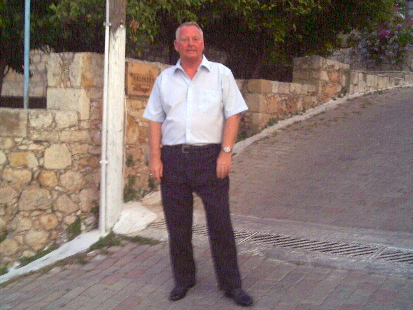 Paul Royle, the first patient treated in the new IR theatre at K&C. He is pictured outside wearing a white short-sleeved shirt and dark trousers.
